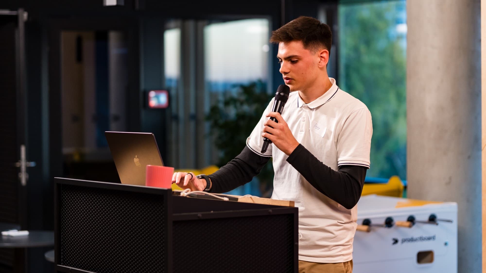 Petr Kynčl presenting a project on stage in Prague